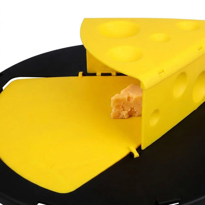 Close-up of a piece of cheese as bait, tucked against the base of the wedge on the yellow plate